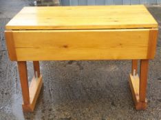 A modern pine drop flap kitchen table