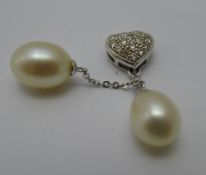A diamond and pearl pendant