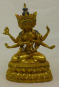 A gilt bronze deity with painted detail