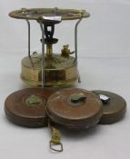 Three leather tape measures and a brass Primus stove