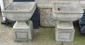 A pair of pedestal garden urns