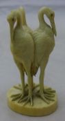 A 19th century carved ivory group of three storks