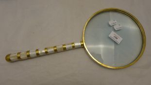 A large mother-of-pearl magnifying glass