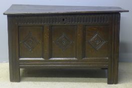 An 18th century panelled oak coffer The hinged rectangular lid above the carved three panel front,