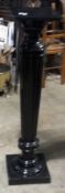 A reeded ebonised torchere