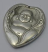 A white metal pendant of Buddha