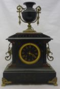 A black marble clock with urn finial