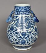 A Chinese blue and white porcelain twin handled baluster vase Worked with dragons amongst lotus