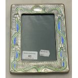 An Art Nouveau style sterling silver and enamel photograph frame
