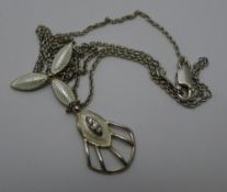 An Art Nouveau/Deco style white metal enamelled pendant and chain