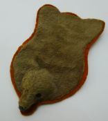 A vintage dolls house rug formed as a bear skin