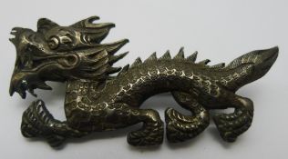 A Chinese silver brooch in the form of a dragon,