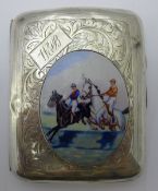 A silver cigarette case depicting a horse racing scene