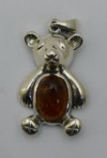 A silver pendant formed as a bear