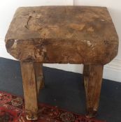A rustic French chopping block table