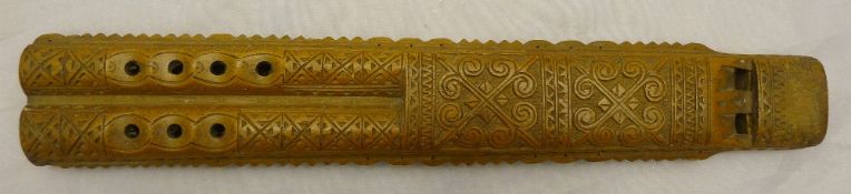 An ornately carved South American flute