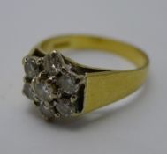 An 18 ct gold and diamond daisy cluster ring