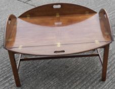 A reproduction butler's tray table