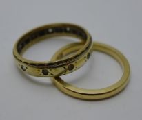 A 9 ct gold wedding band, together with a 9 ct gold eternity ring (5.