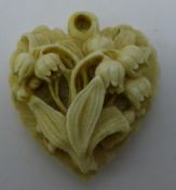 A Victorian carved ivory heart shaped pendant