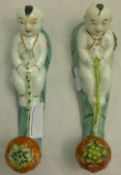 A pair of Chinese Export porcelain wall hooks,