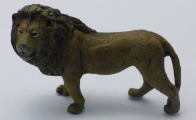 A cold painted bronze model of a lion