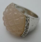 A silver and rose quartz ring
