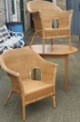 A pair of wicker armchairs and a modern dining table