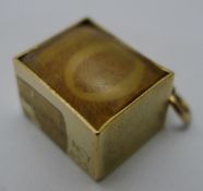 A 9 ct gold cased ten shilling note pendant/charm