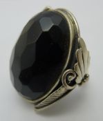 A silver and black stone ring