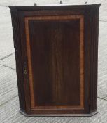 A George III oak hanging corner cupboard