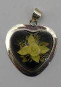 A heart shaped floral pendant
