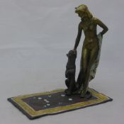 A cold painted bronze figure of a nude lady with a panther