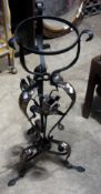 An Arts and Crafts wrought iron and copper jardiniere stand