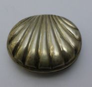 A small silver box in the form of a shell