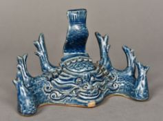 A Chinese porcelain brush holder Centred with a mythical beast mask with allover blue glaze.