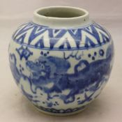 A small 18th/19th century Chinese blue and white ovoid vase decorated with temple lions chasing a