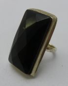 A silver and black stone ring