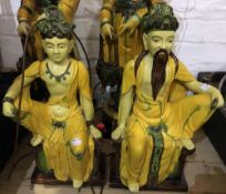 A pair of Chinese pottery figural lamps formed as an Emperor and Empress