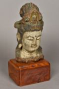 A Chinese carved wood and polychrome decorated Buddha's head Mounted on a later plinth base.