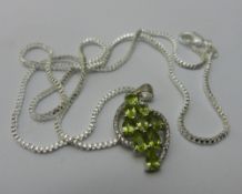 A green stone set pendant on a silver chain