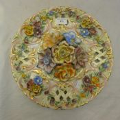 An Italian majolica flower encrusted charger