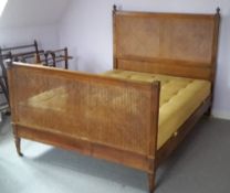 A 19th century French caned walnut double bed
