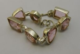 A silver and pink stone bracelet