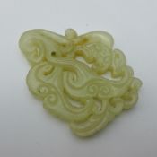 A Chinese carved and pierced jade pendant