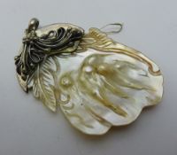 A silver and shell pendant