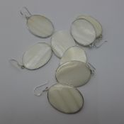 Four pairs of silver and shell earrings