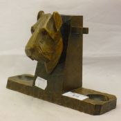 A carved wood pipe rack worked with a terrier mask