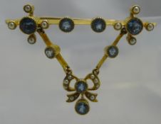 An unmarked yellow metal blue topaz and seed pearl set pendant bar brooch (5.2 grammes all in).