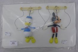 A Mickey Mouse puppet and a Donald Duck puppet